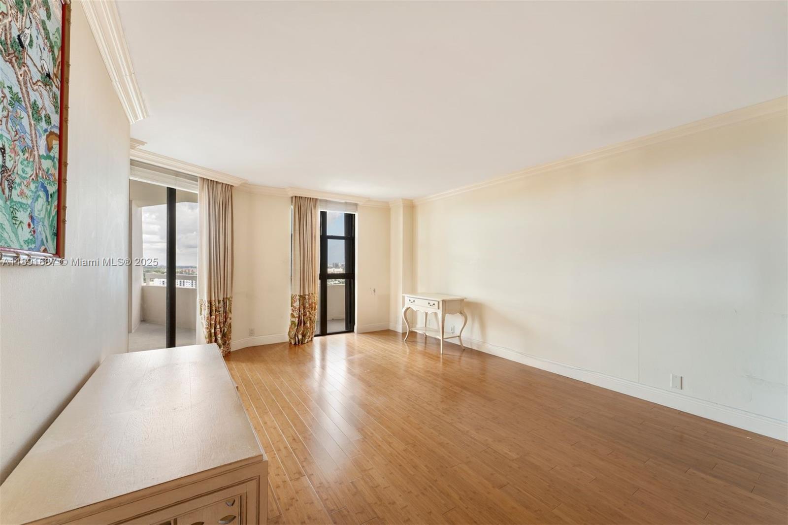 1000 Quayside Terrace, Unit PH9 Miami, FL 33138 - Photo 17 of 27 a view of an empty room with wooden floor and a window