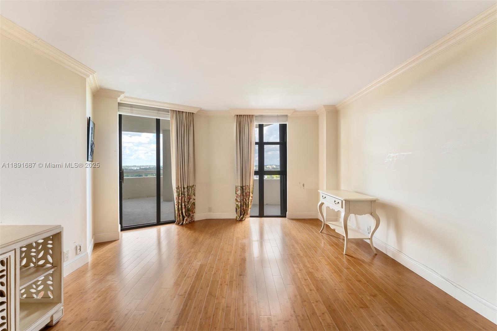 1000 Quayside Terrace, Unit PH9 Miami, FL 33138 - Photo 18 of 27 a view of an empty room with wooden floor