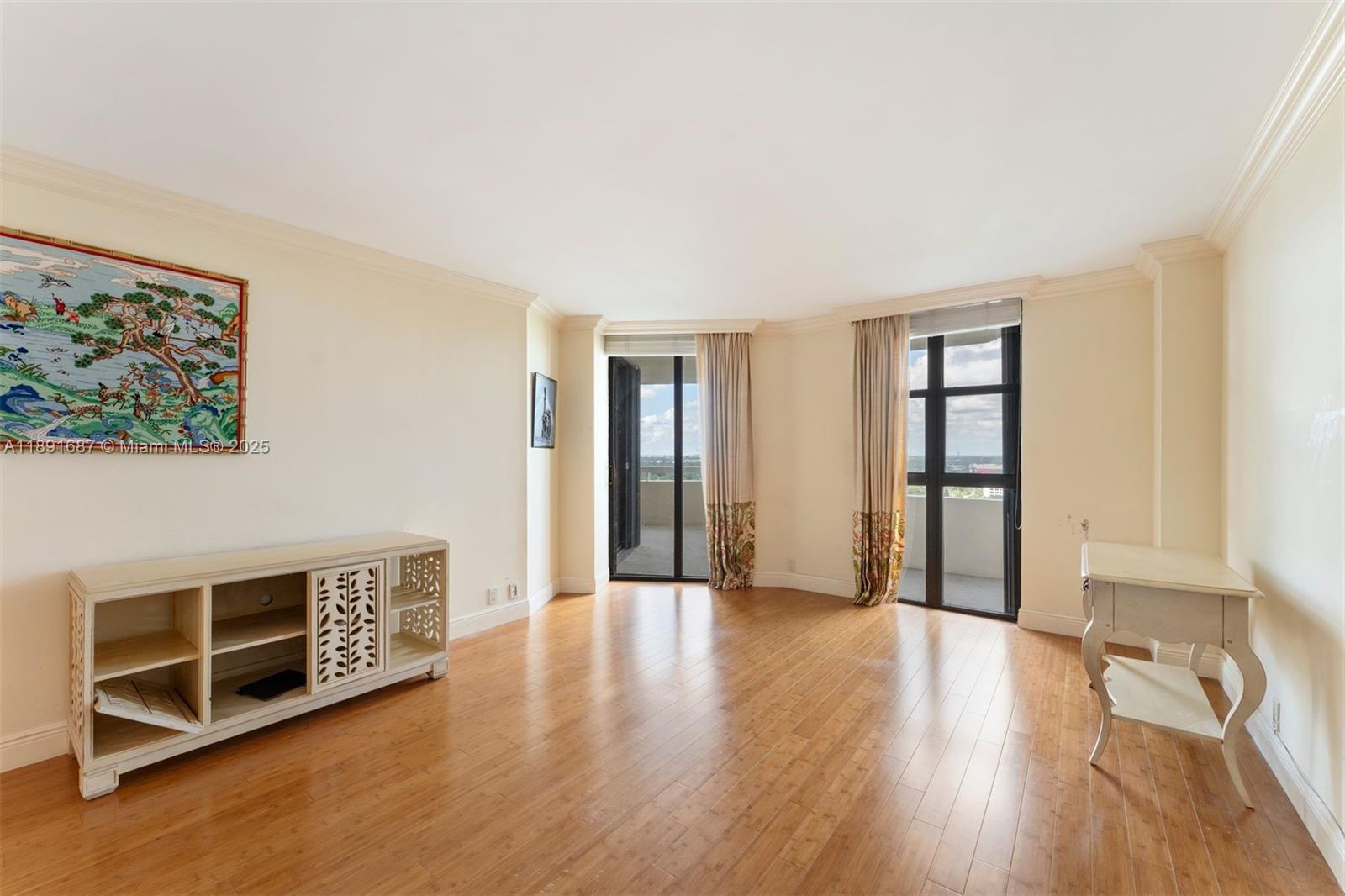 1000 Quayside Terrace, Unit PH9 Miami, FL 33138 - Photo 19 of 27 a view of an empty room with wooden floor and a window