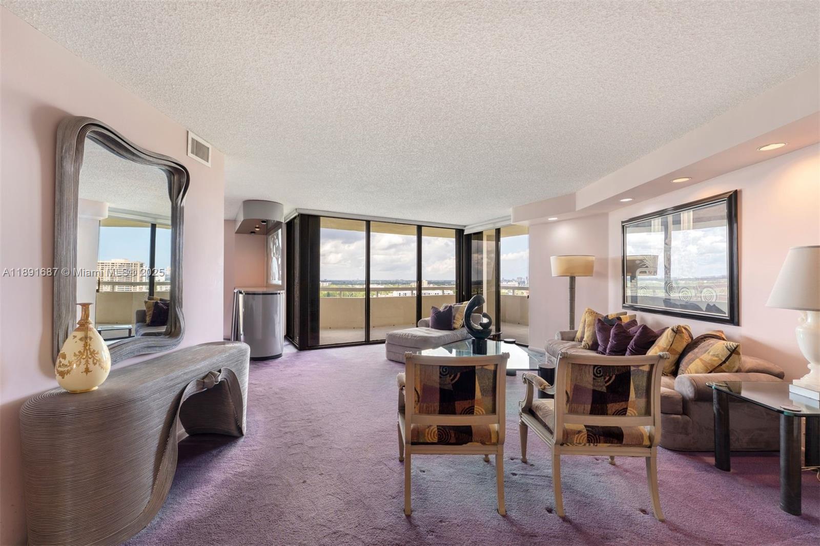 1000 Quayside Terrace, Unit PH9 Miami, FL 33138 - Photo 2 of 27 a living room with furniture and a floor to ceiling window