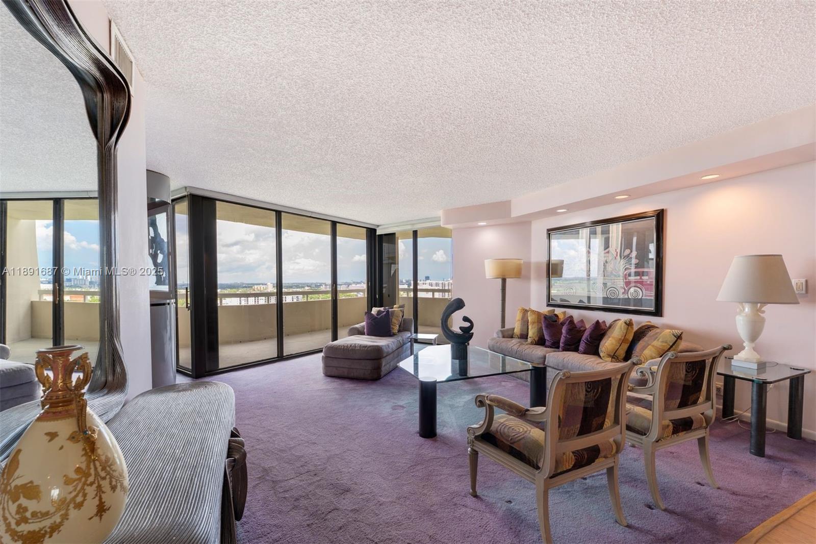 1000 Quayside Terrace, Unit PH9 Miami, FL 33138 - Photo 3 of 27 a living room with furniture and a large window