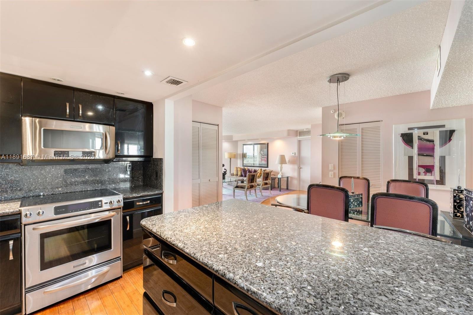1000 Quayside Terrace, Unit PH9 Miami, FL 33138 - Photo 10 of 27 a kitchen with stainless steel appliances granite countertop a stove and a sink