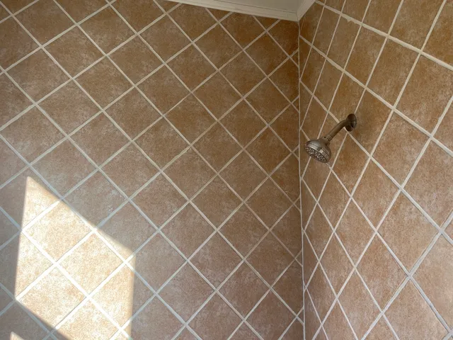 an outdoor space with wooden wall and a window