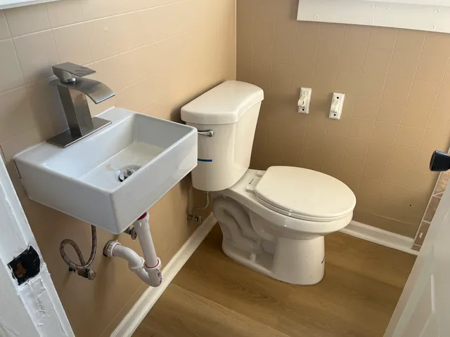 a white toilet sitting next to a bathroom sink
