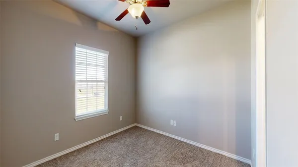an empty room with a empty space and a ceiling fan
