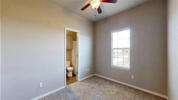 an empty room with closet and a hallway