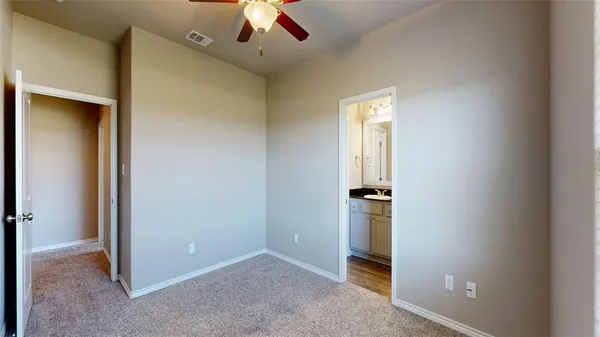 a bathroom with a granite countertop sink a toilet and a mirror