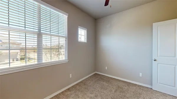 a view of an empty room with a ceiling fan