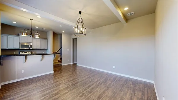 a view of a kitchen with a sink and wooden floor