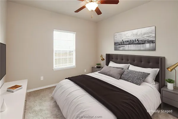 a bedroom with bed and a potted plant