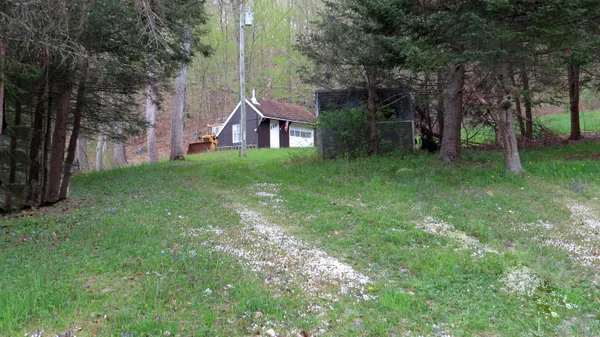 a view of a house with a backyard