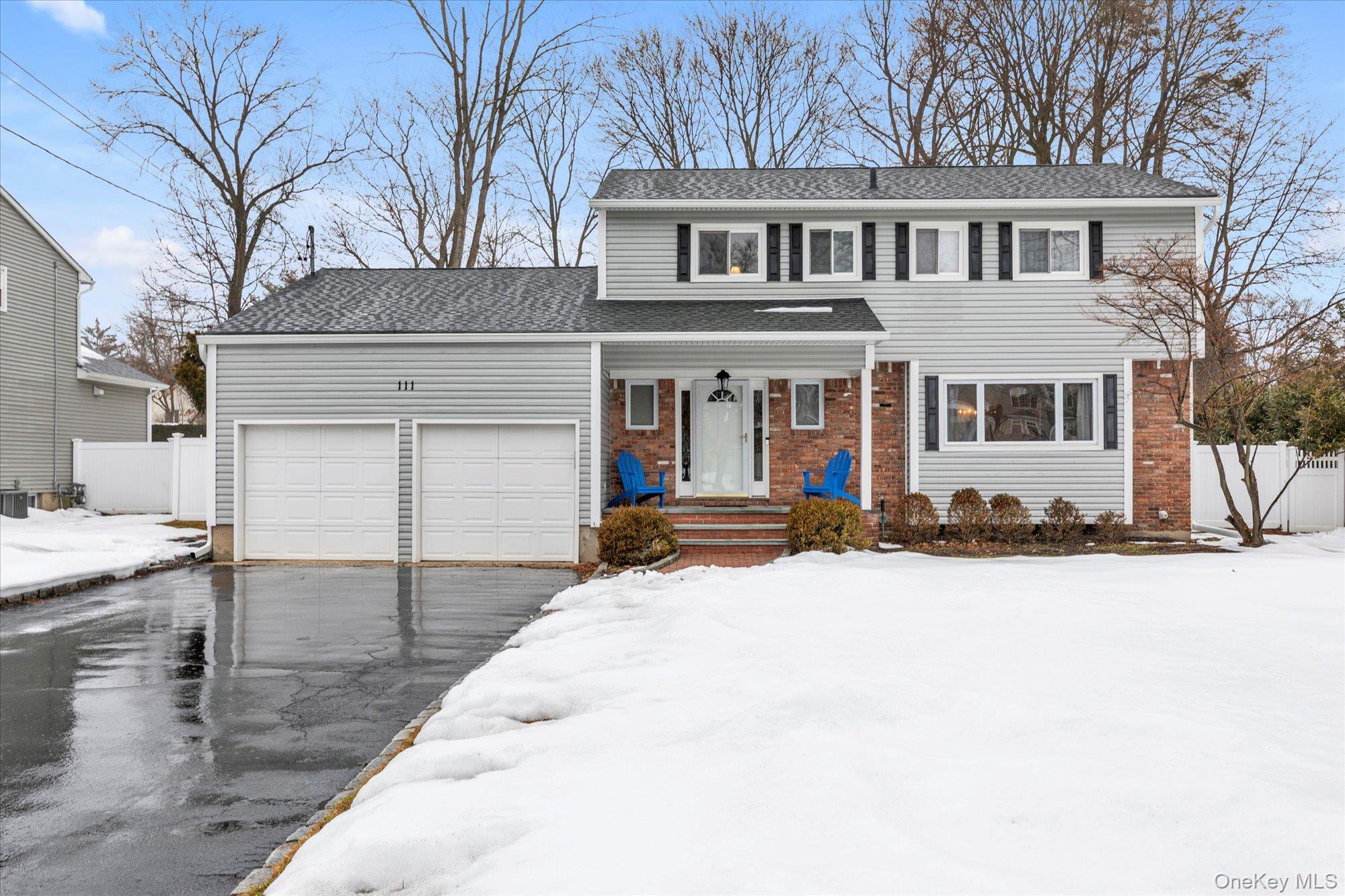 111 Cocks Lane Locust Valley, NY 11560 - Photo 1 of 23 a front view of a house with a yard covered in snow