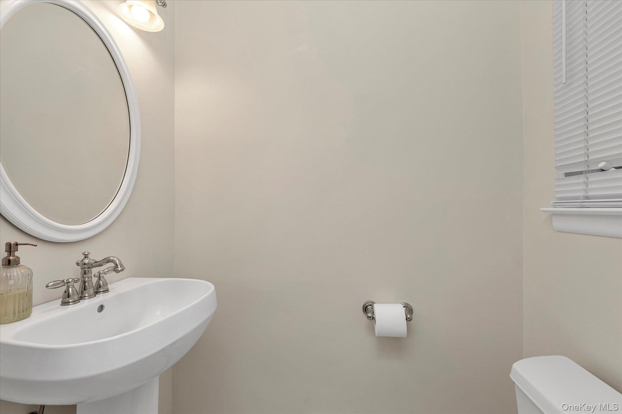 111 Cocks Lane Locust Valley, NY 11560 - Photo 13 of 23 a bathroom with a sink and a mirror