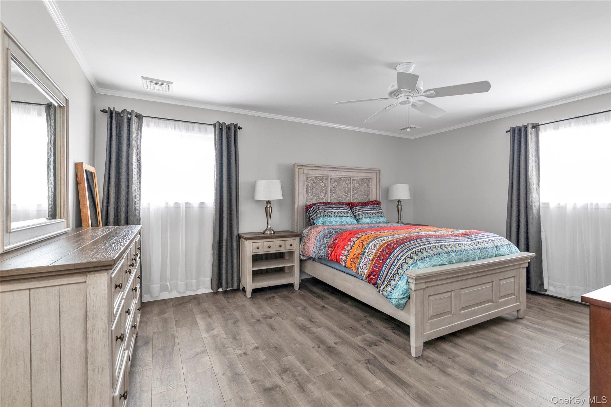 111 Cocks Lane Locust Valley, NY 11560 - Photo 14 of 23 a bedroom with a bed and a chandelier