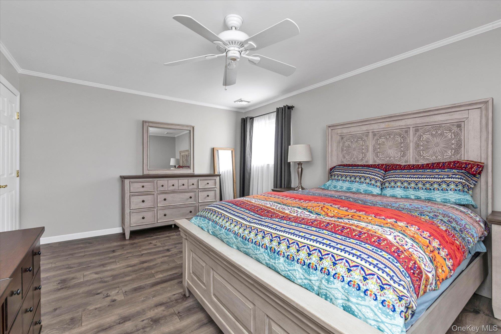 111 Cocks Lane Locust Valley, NY 11560 - Photo 15 of 23 a bedroom with a large bed and a chandelier