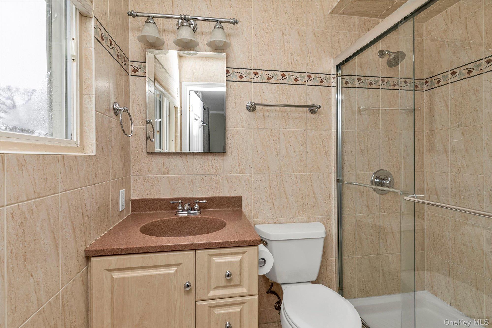111 Cocks Lane Locust Valley, NY 11560 - Photo 16 of 23 a bathroom with a sink a toilet and shower