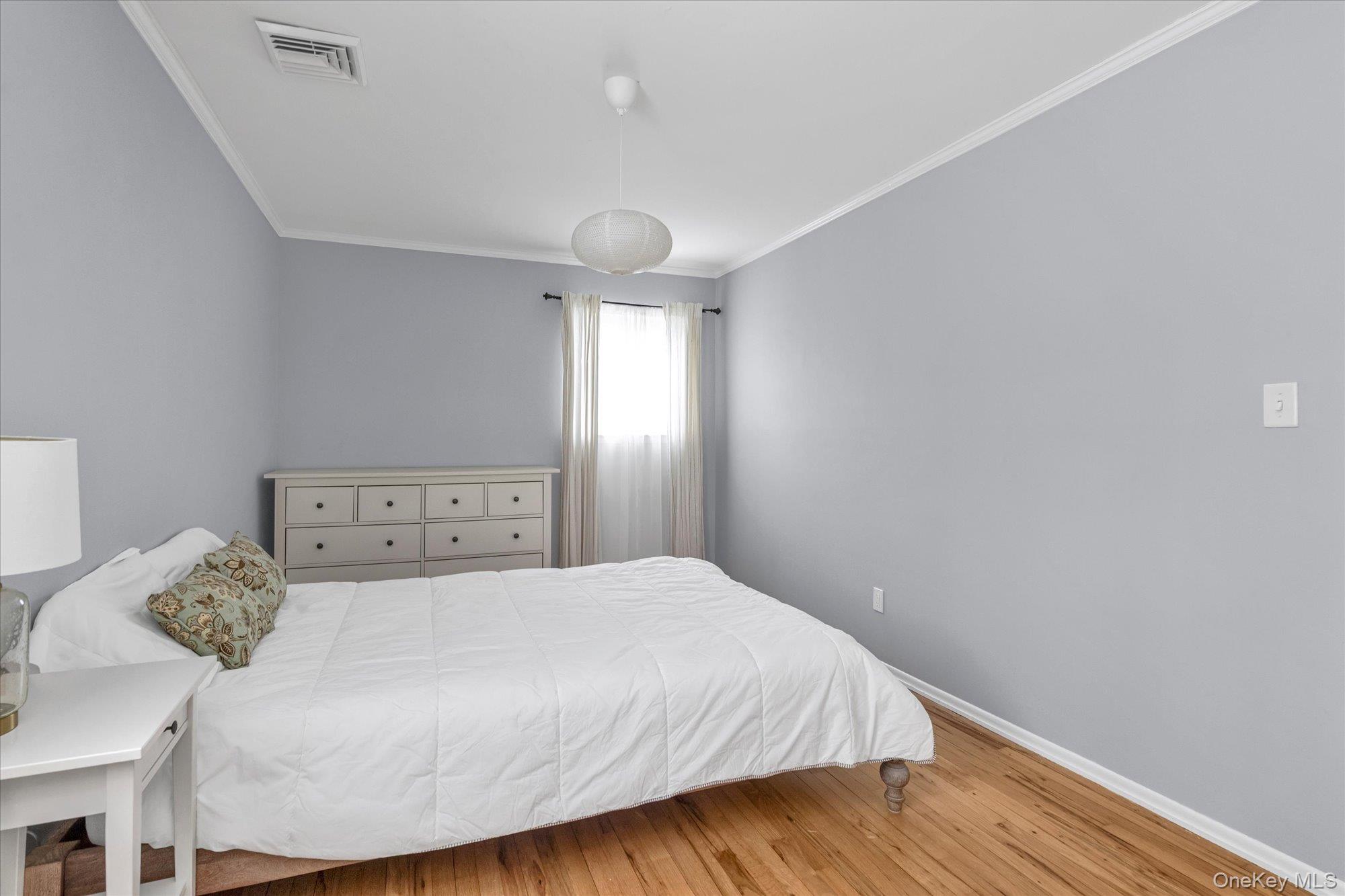 111 Cocks Lane Locust Valley, NY 11560 - Photo 18 of 23 a bedroom with a bed and wooden floor