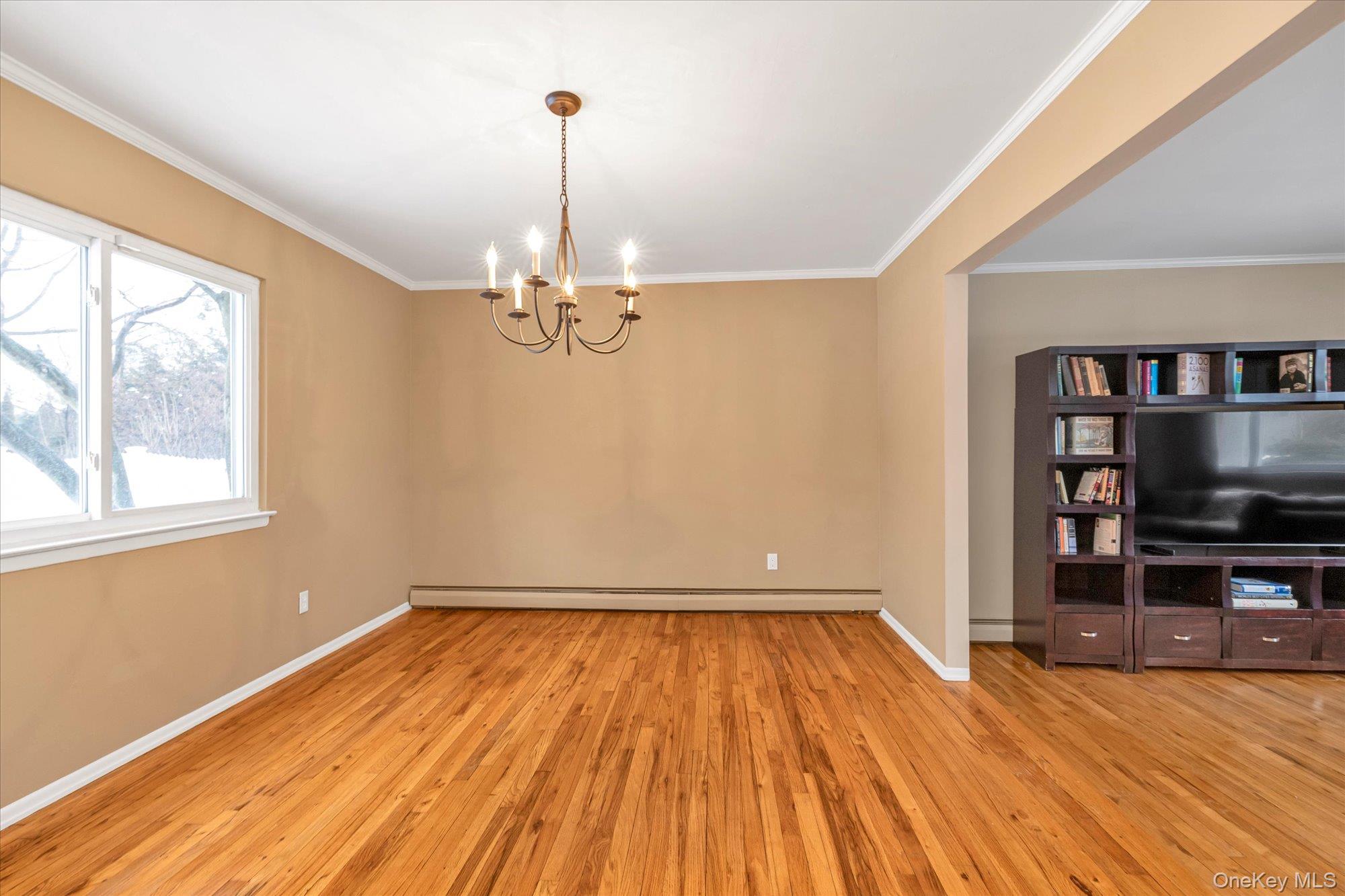 111 Cocks Lane Locust Valley, NY 11560 - Photo 7 of 23 a view of a room with wooden floor flat screen tv and windows