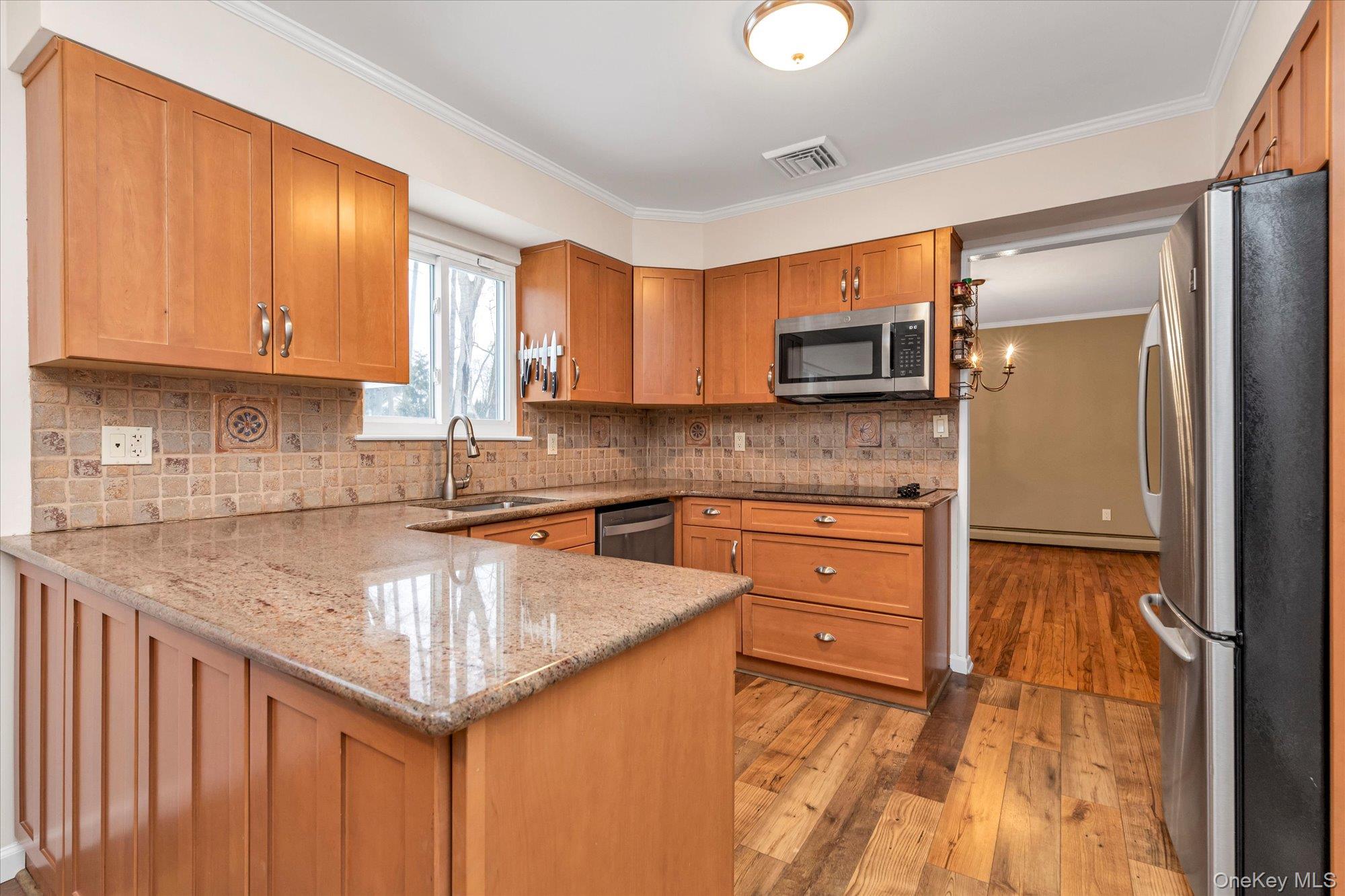 111 Cocks Lane Locust Valley, NY 11560 - Photo 8 of 23 a kitchen with stainless steel appliances granite countertop a sink stove and microwave