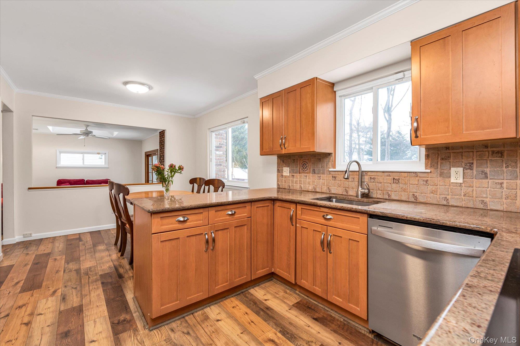 111 Cocks Lane Locust Valley, NY 11560 - Photo 9 of 23 a kitchen with stainless steel appliances granite countertop a sink a stove cabinets counter space and a window