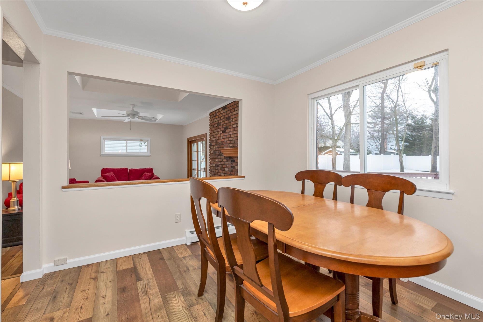 111 Cocks Lane Locust Valley, NY 11560 - Photo 10 of 23 a view of a dining room with furniture a chandelier and wooden floor