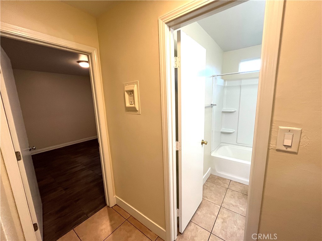 4329 East 55th Street, Unit E Maywood, CA 90270 - Photo 8 of 12 a view of a bathroom from a hallway