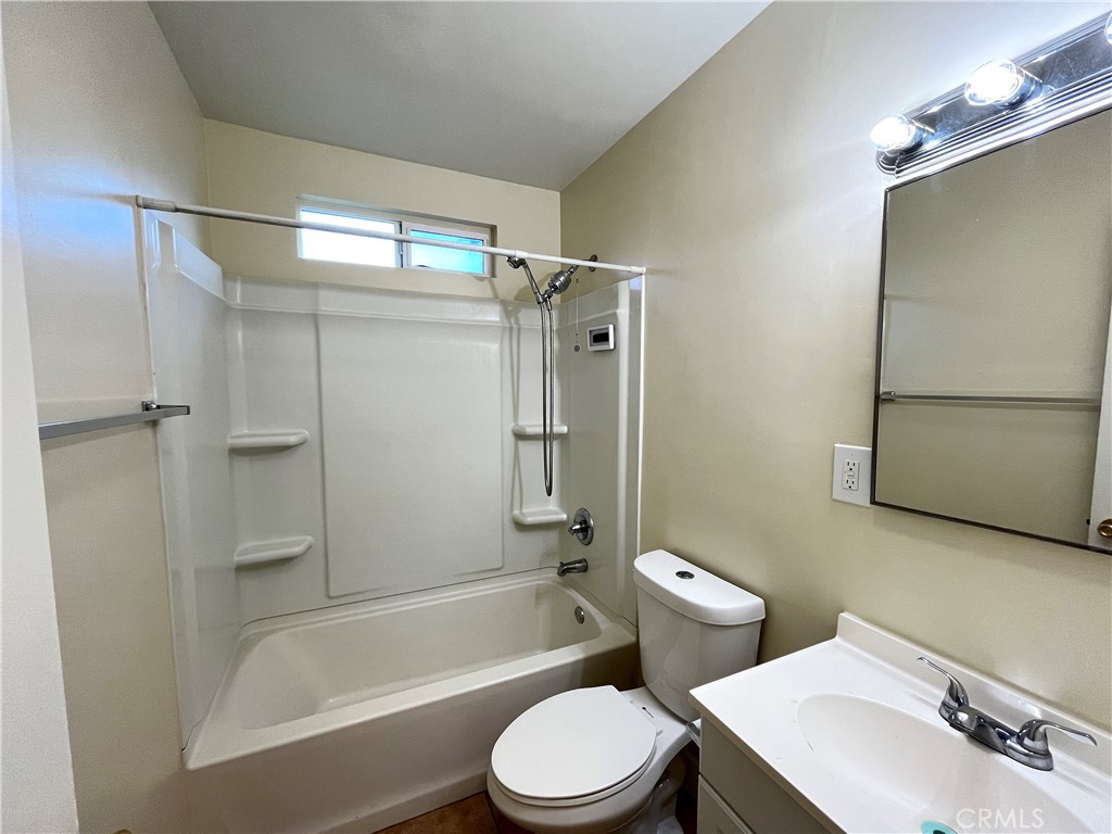 4329 East 55th Street, Unit E Maywood, CA 90270 - Photo 9 of 12 a bathroom with a sink toilet and shower