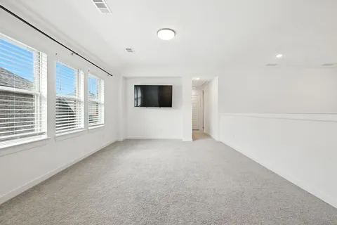 a view of a livingroom with a ceiling fan and window