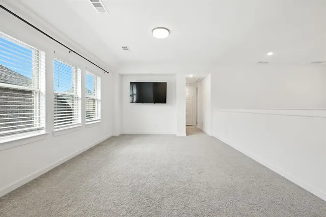 a view of a livingroom with a ceiling fan and window