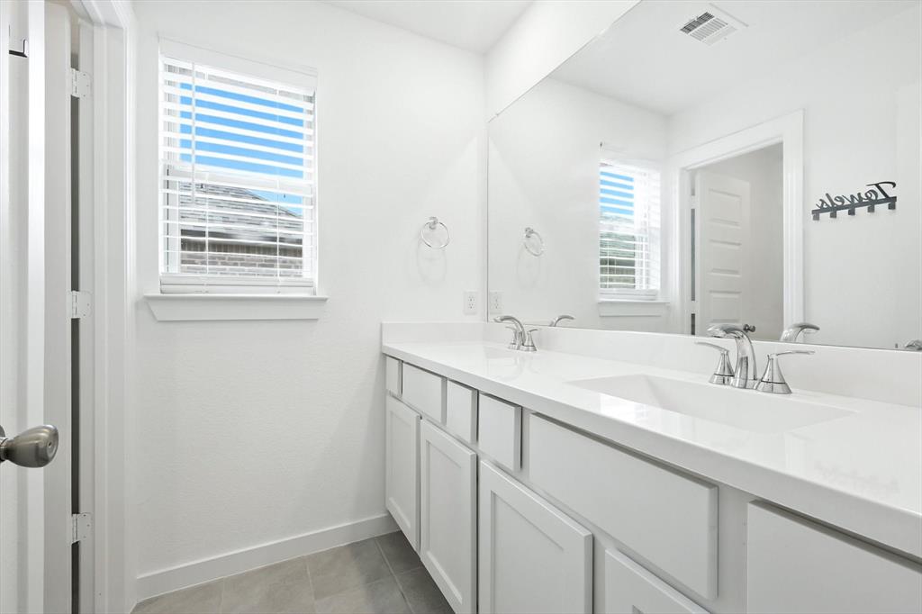 2328 Neff Lane Forney, TX 75126 - Photo 22 of 30 a bathroom with a double vanity sink and a mirror