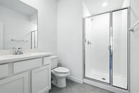 a bathroom with a toilet a sink and a mirror