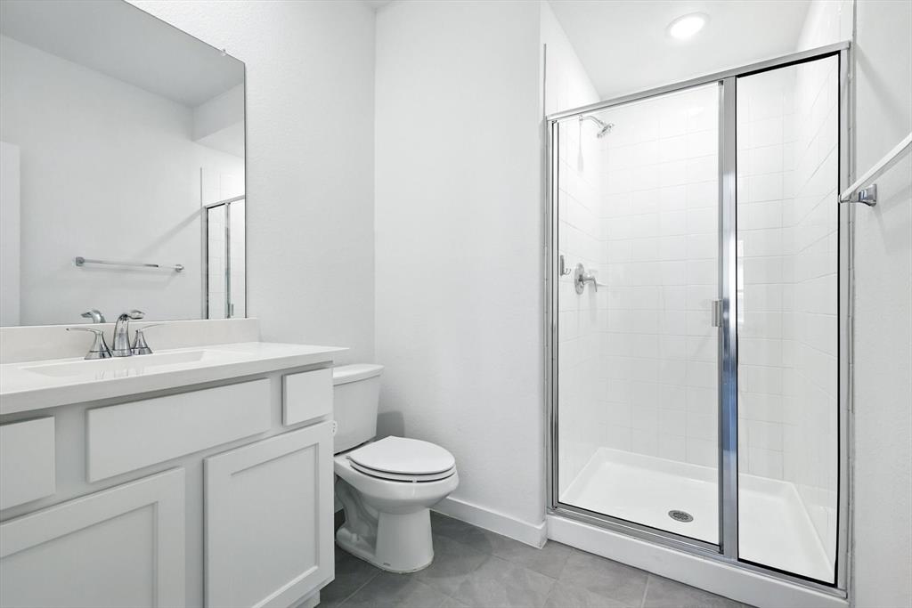 2328 Neff Lane Forney, TX 75126 - Photo 24 of 30 a bathroom with a toilet a sink and a mirror