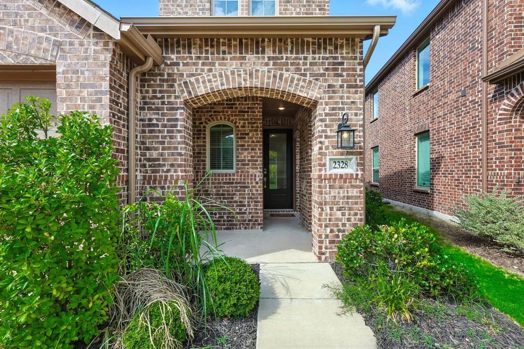 2328 Neff Lane Forney, TX 75126 - Photo 3 of 30 a front view of a house with a garden
