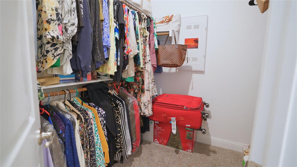 1101 Ginger Road Aubrey, TX 76227 - Photo 12 of 16 a view of walk in closet with clothes and shoes