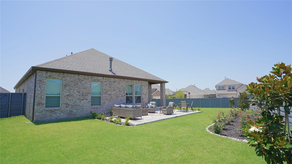 1101 Ginger Road Aubrey, TX 76227 - Photo 14 of 16 a front view of a house with a yard table and chairs