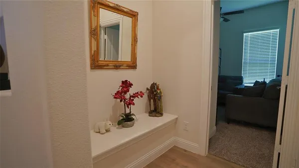 a view of hallway with livingroom and furniture
