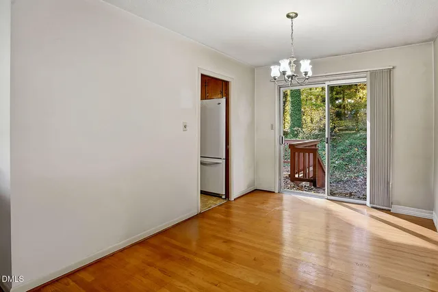 a view of an empty room with glass door and balcony