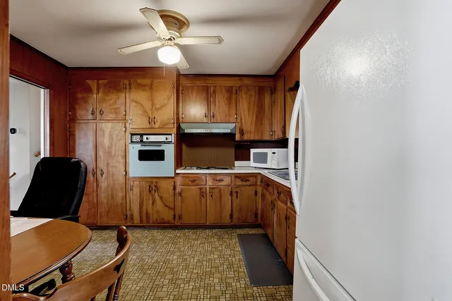 a kitchen with stainless steel appliances granite countertop a stove top oven