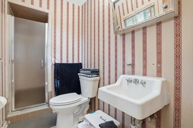 a white toilet sitting next to a bathroom sink