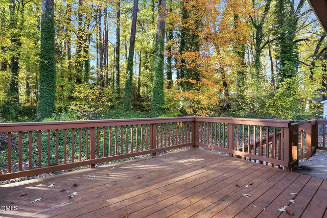 a balcony with wooden floor and fence