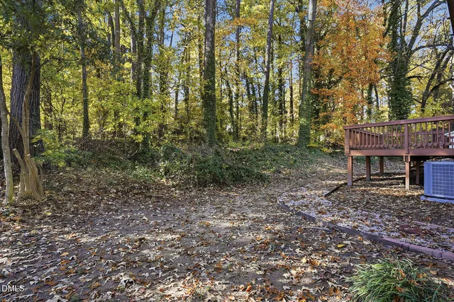 a view of house with a backyard