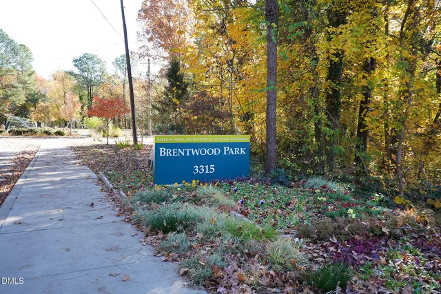 a sign that is sitting in front of flowers