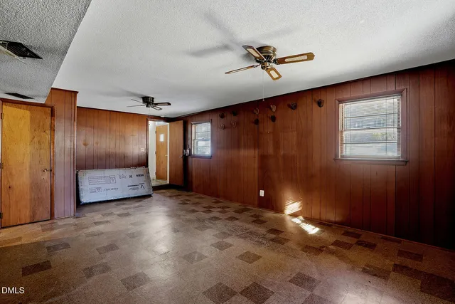an empty room with windows and closet