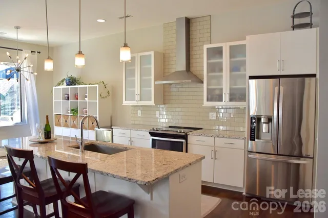a kitchen with refrigerator cabinets and wooden floor
