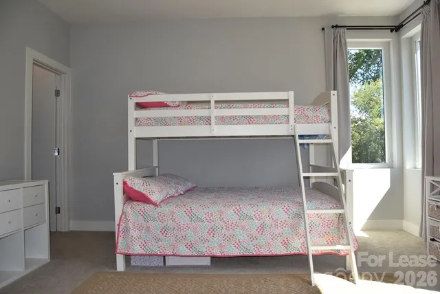 a bathroom with a granite countertop sink and a toilet