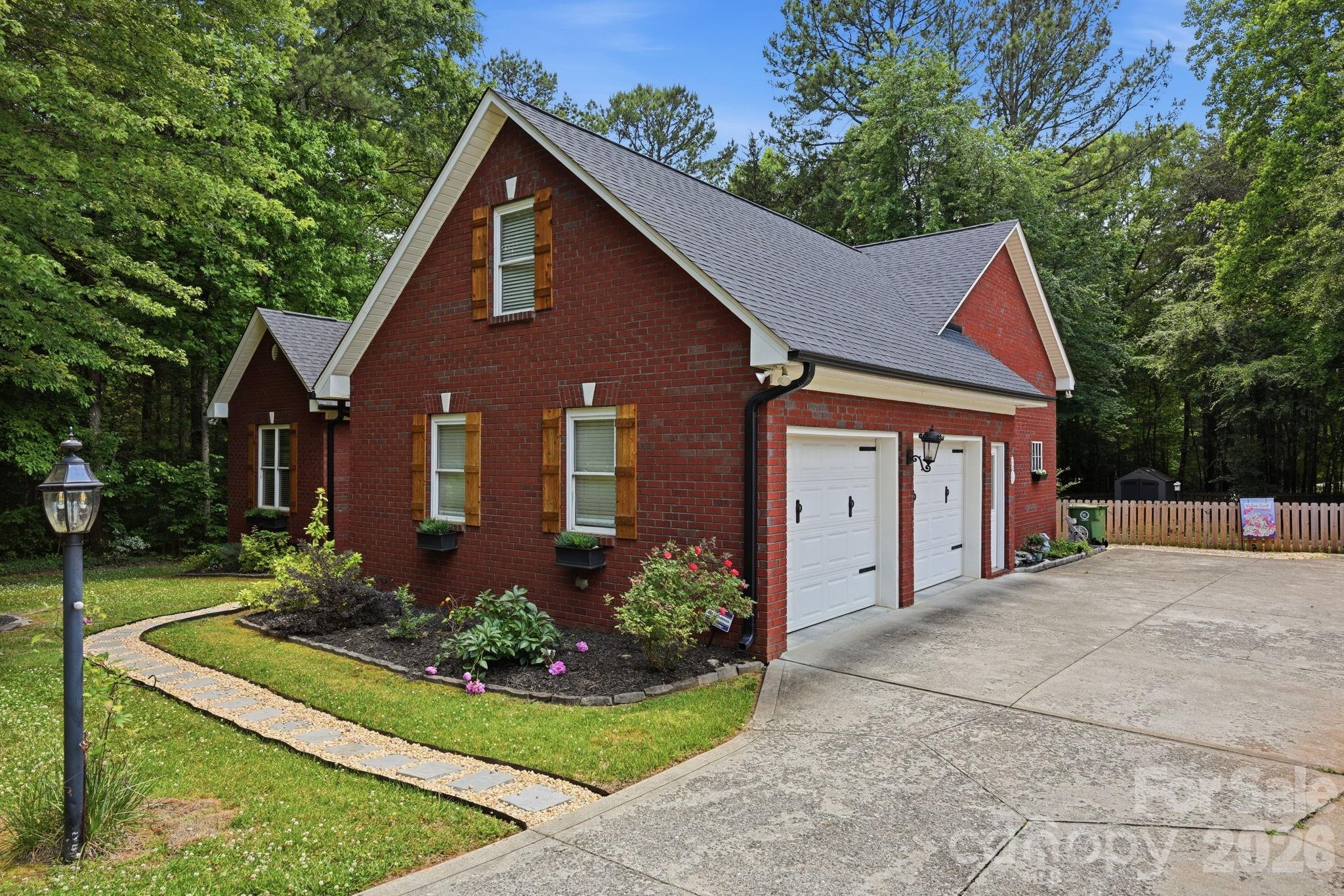 145 Upper Spencer Mountain Road Stanley, NC 28164 - Photo 4 of 29 a front view of a house with a yard and garage