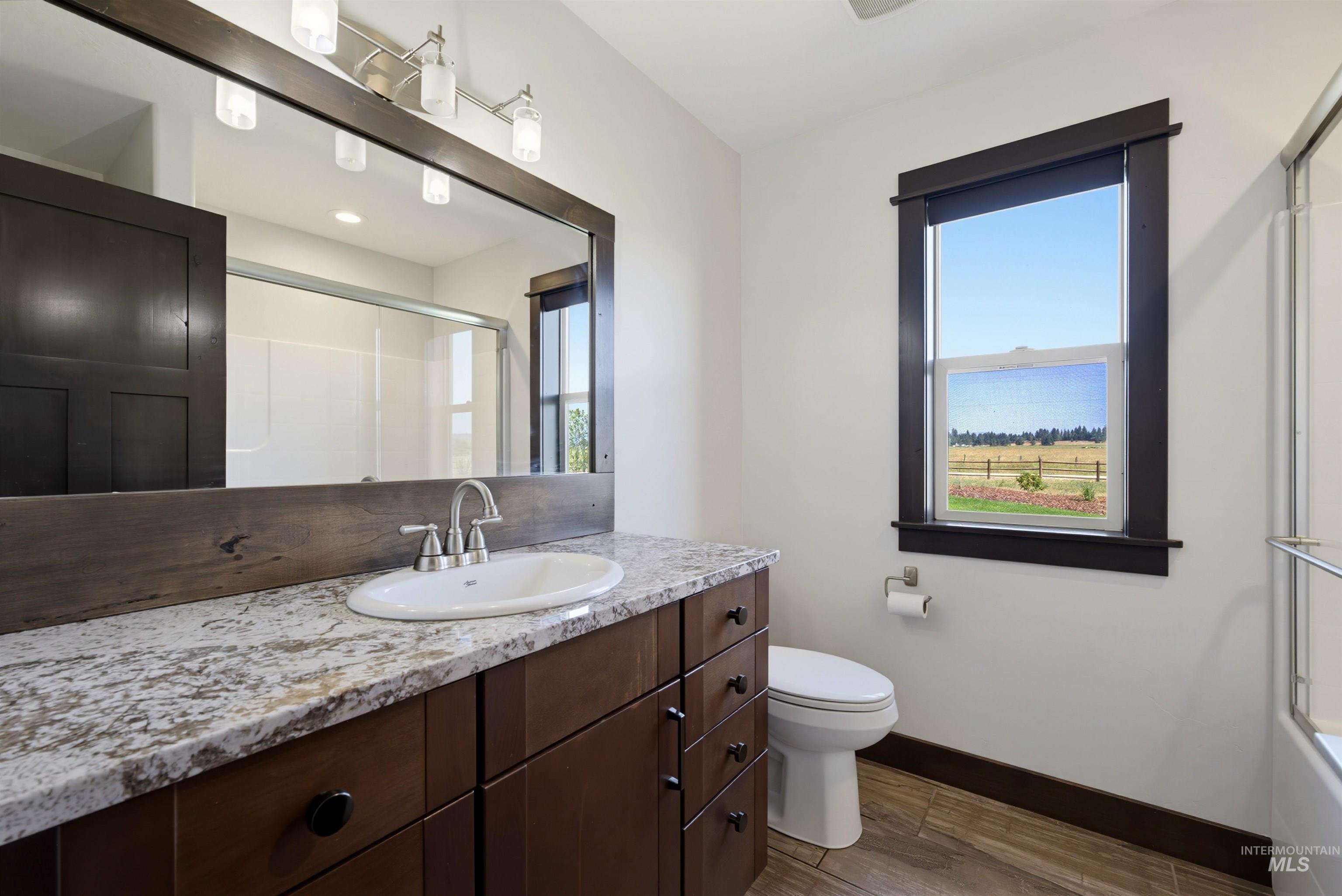 13945 Galloping Road McCall, ID 83638 - Photo 25 of 50 Bathroom vanity featuring a granite countertop with an undermount sink and brushed nickel faucet