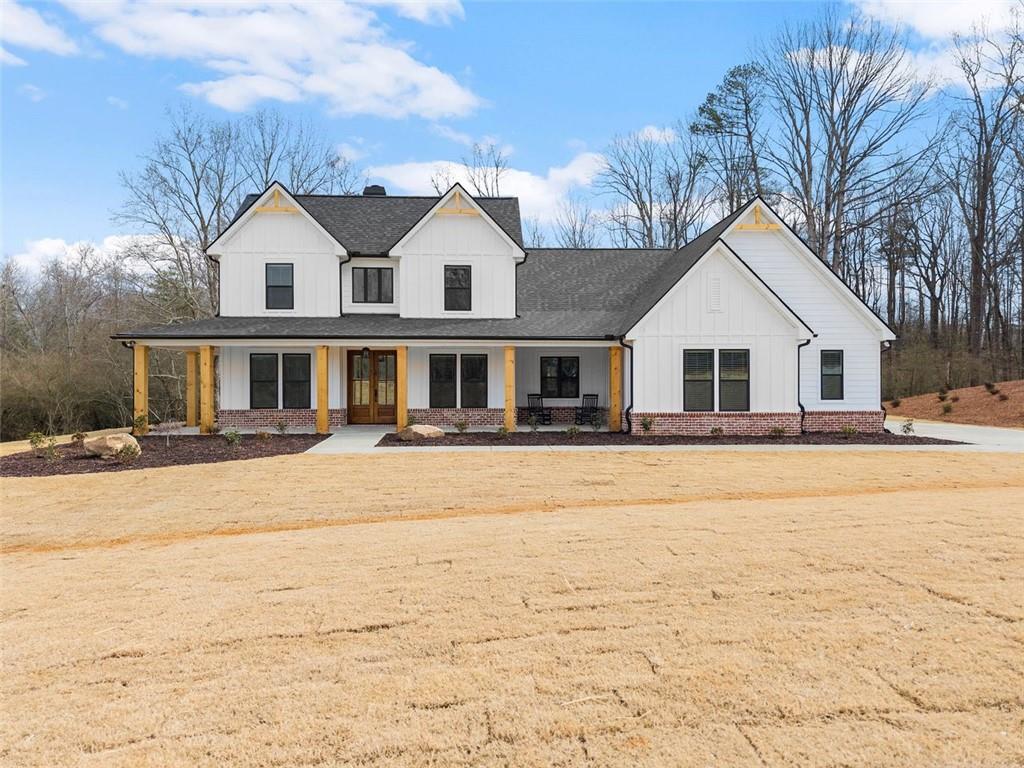 1087 Webb West Road Cleveland, GA 30528 - Photo 1 of 1 a view of a white house with a large yard and large trees