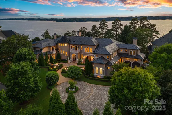a view of a house with a yard and potted plants