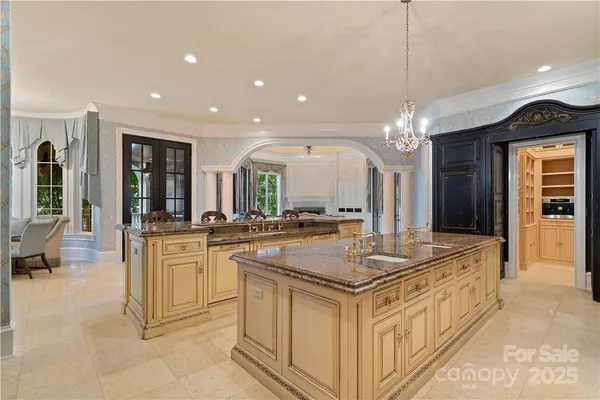 a bathroom with a granite countertop sink a large mirror and a shower